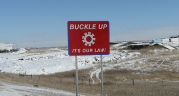 PineRidgeSign-350w.jpg Photo: road sign: Buckle up - it's our law