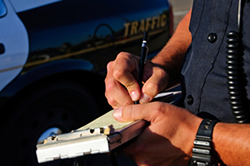 police writing ticket 250w Policeman writing a traffic ticket